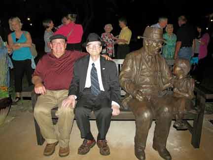 Dr. Dohner sitting on his life size statue